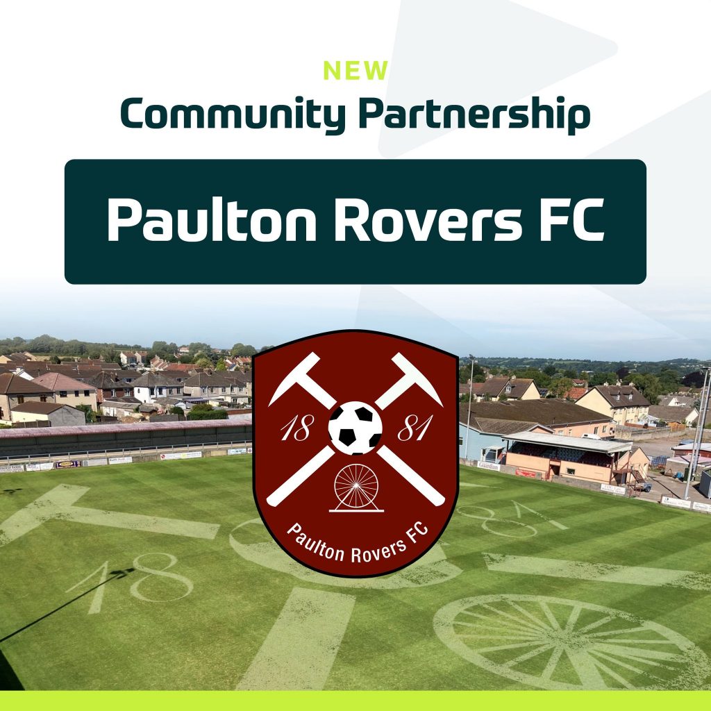 An aerial view of the Paulton Rovers FC stadium, with the club's crest and patterned pitch surrounded by houses and greenery. Text highlights an exciting new community partnership with Paulton Rovers FC. | Driveways Plus