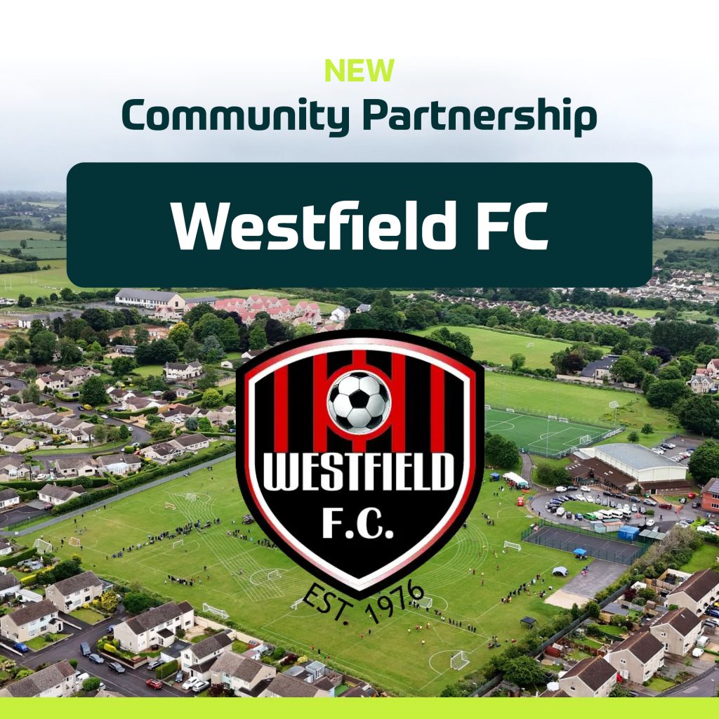 Aerial view of a town with a football pitch. Text reads "NEW Community Partnership Westfield FC," celebrating the football club’s 50th anniversary, with the Westfield F.C. logo (a football and stripes) and "Est. 1976" over the pitch. | Driveways Plus